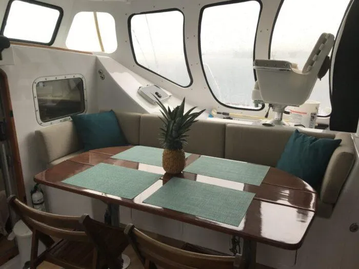 Vitesse Yacht Photos Pics Interior of 1989 Lagoon 55 yacht with dining table and seating area.