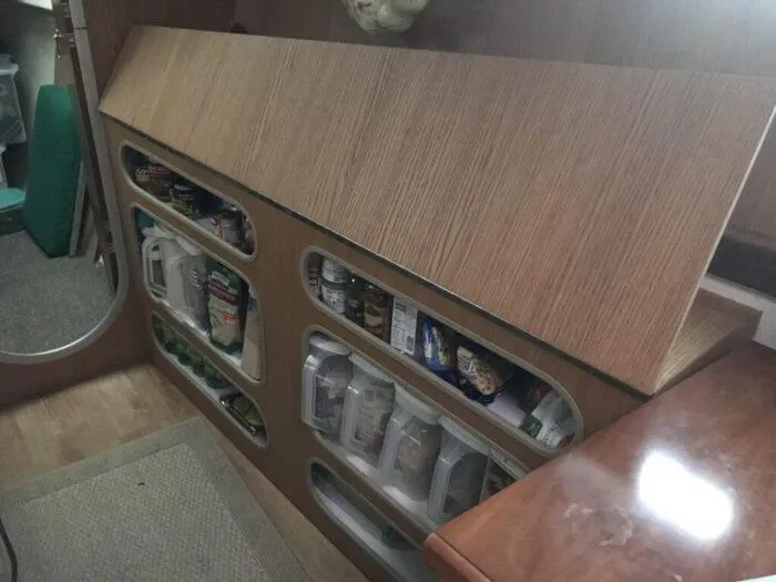 Vitesse Yacht Photos Pics 1989 Lagoon 55 yacht interior storage compartments with food supplies.