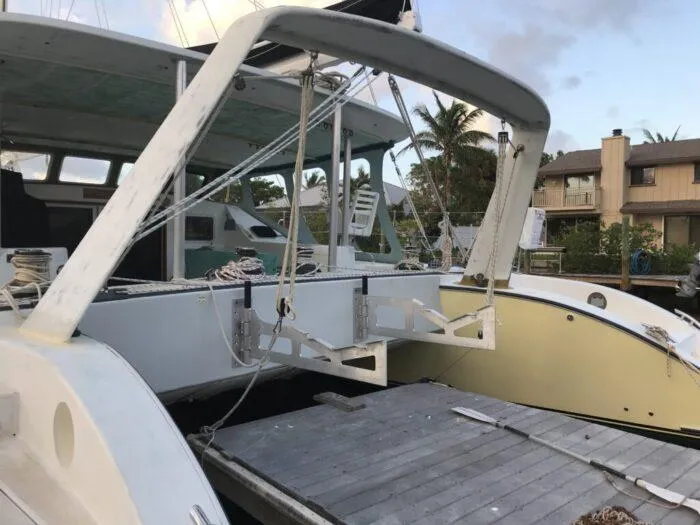 Vitesse Yacht Photos Pics 1989 Lagoon 55 catamaran docked at a marina.