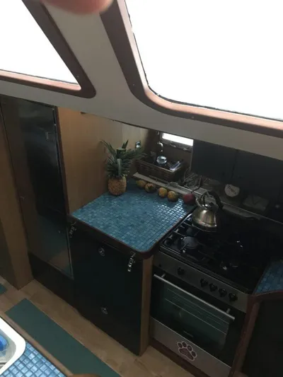 Vitesse Yacht Photos Pics Interior kitchen of 1989 Lagoon 55 yacht with blue countertops and stainless steel appliances.