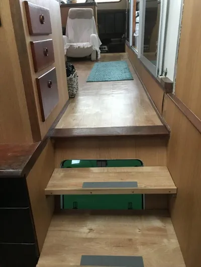 Vitesse Yacht Photos Pics Interior of 1989 Lagoon 55 yacht with wooden stairs and cozy seating area.