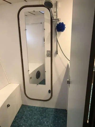 Vitesse Yacht Photos Pics 1989 Lagoon 55 yacht bathroom with shower and blue tiled floor.
