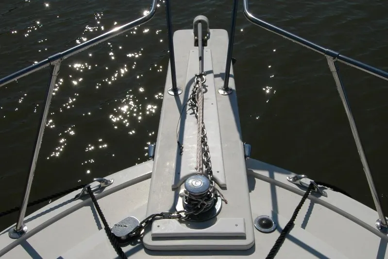 Vesper Yacht Photos Pics Bow of 1987 Bertram 33 Sport Fisherman with anchor chain, glistening water.