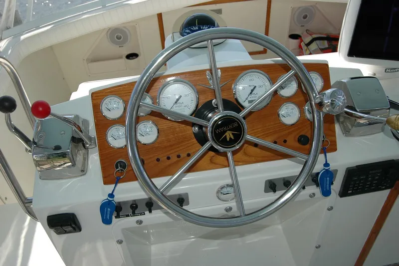 Vesper Yacht Photos Pics 1987 Bertram 33 Sport Fisherman helm with gauges and steering wheel.