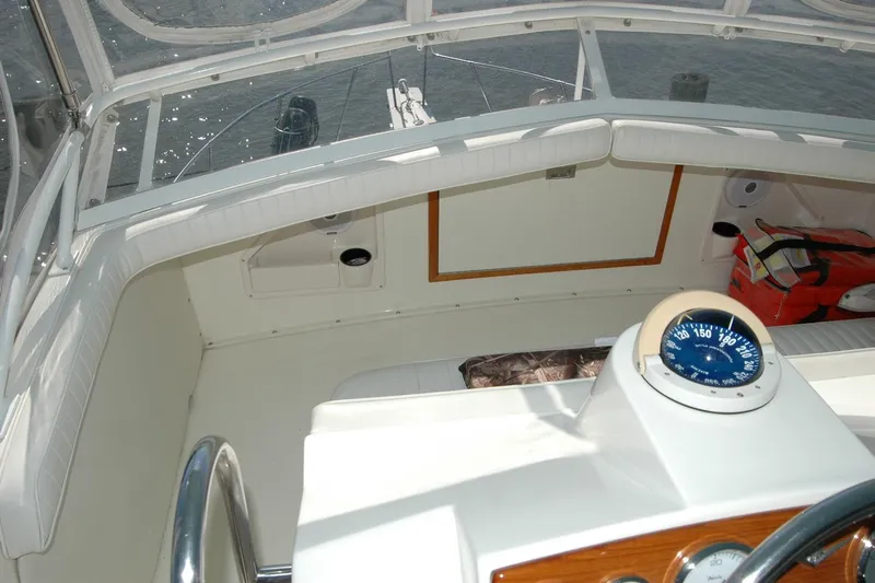 Vesper Yacht Photos Pics 1987 Bertram 33 Sport Fisherman cockpit with compass and seating area.