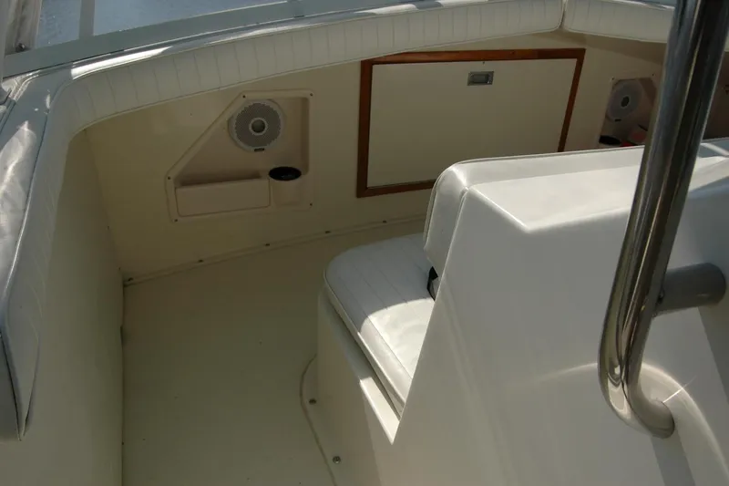 Vesper Yacht Photos Pics 1987 Bertram 33 Sport Fisherman interior with white seating and speaker system.