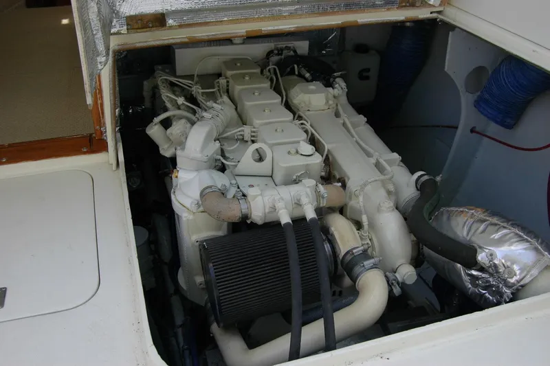 Vesper Yacht Photos Pics Engine compartment of a 1987 Bertram 33 Sport Fisherman boat, showcasing detailed machinery.