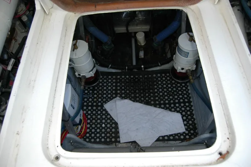 Vesper Yacht Photos Pics Engine compartment of a 1987 Bertram 33 Sport Fisherman boat, showing filters and hoses.