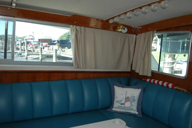 Vesper Yacht Photos Pics Interior of 1987 Bertram 33 Sport Fisherman with blue seating and nautical decor.