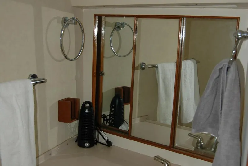 Vesper Yacht Photos Pics Bathroom interior of 1987 Bertram 33 Sport Fisherman with mirror and towels.