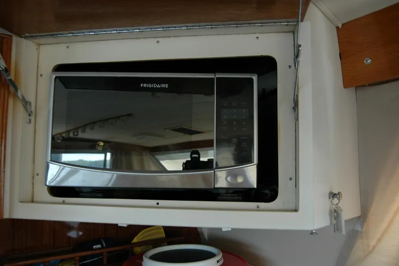 Vesper Yacht Photos Pics Frigidaire microwave installed in 1987 Bertram 33 Sport Fisherman boat interior.