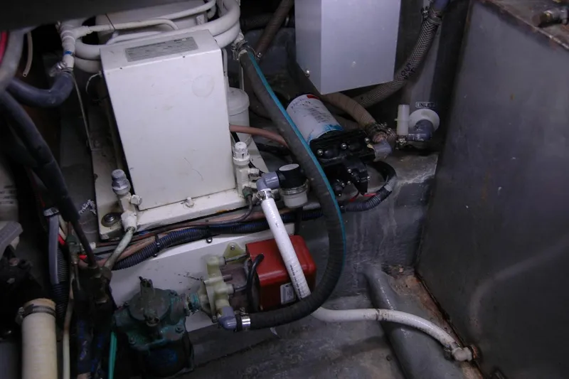 Vesper Yacht Photos Pics Engine room of 1987 Bertram 33 Sport Fisherman with various mechanical components and wiring.