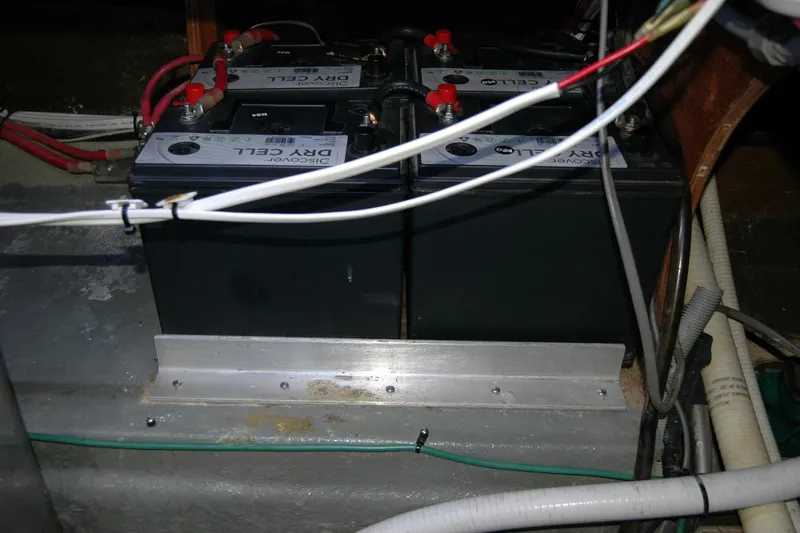 Vesper Yacht Photos Pics Battery compartment of a 1987 Bertram 33 Sport Fisherman boat, featuring dry cell batteries.