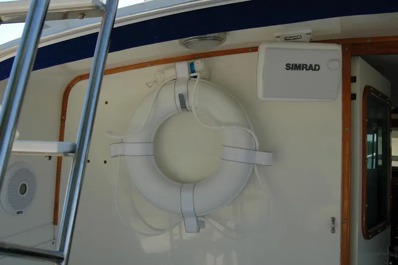 Vesper Yacht Photos Pics 1987 Bertram 33 Sport Fisherman boat interior with life preserver and Simrad equipment.