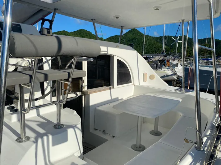 Eugenite Yacht Photos Pics Lagoon 380 catamaran cockpit with seating and table, 2013 model, docked at marina.