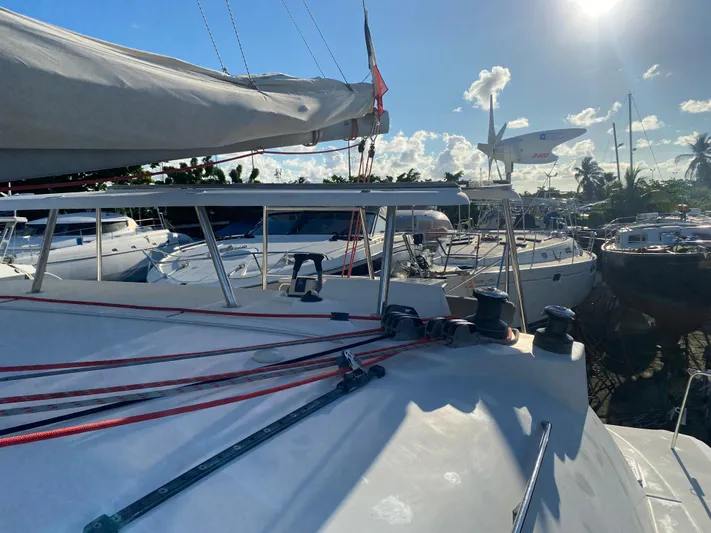 Eugenite Yacht Photos Pics Lagoon 380 catamaran from 2013 docked under a sunny sky with other boats nearby.