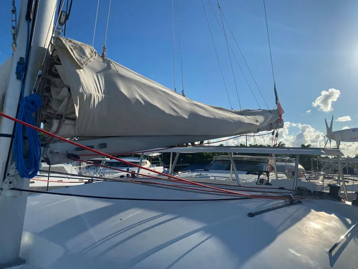Eugenite Yacht Photos Pics Lagoon 380 catamaran sailboat, 2013 model, with sails furled, under a clear blue sky.