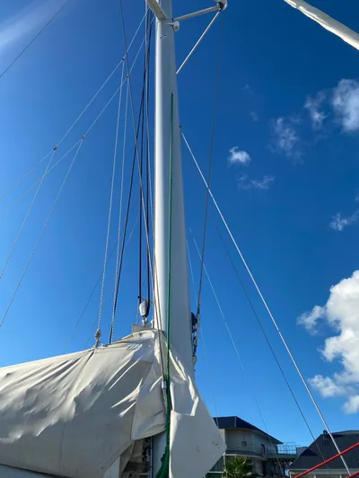 Eugenite Yacht Photos Pics Sailboat mast of a 2013 Lagoon 380 against a clear blue sky.