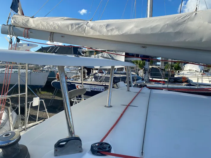 Eugenite Yacht Photos Pics 2013 Lagoon 380 catamaran docked, featuring sails and deck equipment under a clear blue sky.