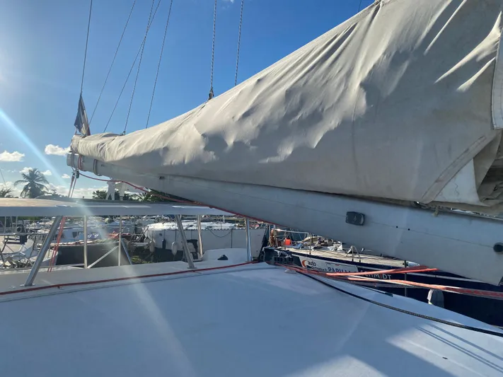 Eugenite Yacht Photos Pics Sail of a 2013 Lagoon 380 catamaran docked under a clear blue sky.