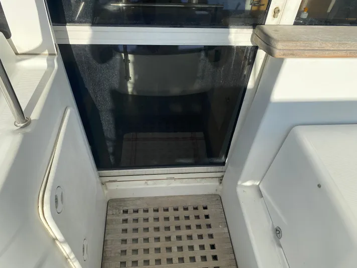 Eugenite Yacht Photos Pics Interior view of a 2013 Lagoon 380 catamaran with wooden flooring and sliding door.