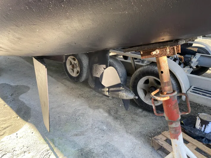 Eugenite Yacht Photos Pics 2013 Lagoon 380 catamaran propeller and rudder on dry dock, with trailer wheels visible.