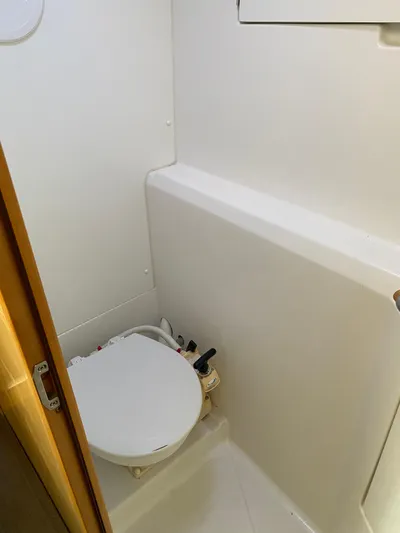 Eugenite Yacht Photos Pics Compact bathroom in a 2013 Lagoon 380 catamaran, featuring a white marine toilet.