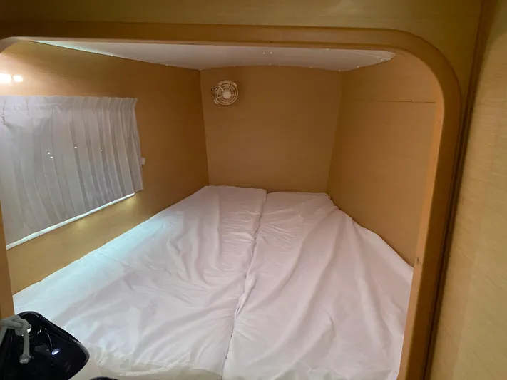 Eugenite Yacht Photos Pics Cozy cabin interior of 2013 Lagoon 380 catamaran with bed and window.