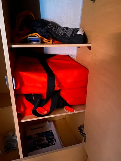 Eugenite Yacht Photos Pics Storage compartment on a 2013 Lagoon 380 with safety equipment and life jackets.