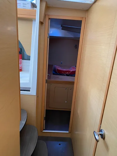 Eugenite Yacht Photos Pics Interior view of 2013 Lagoon 380 catamaran, featuring wooden cabinetry and compact design.