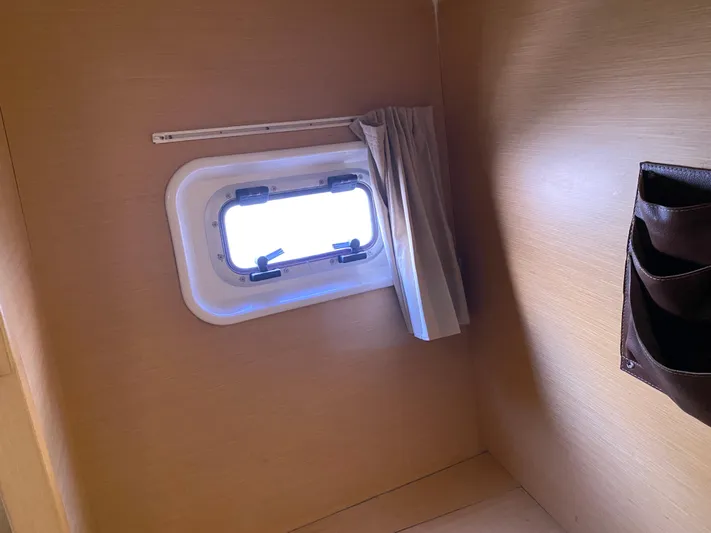 Eugenite Yacht Photos Pics Interior cabin window of a 2013 Lagoon 380 catamaran with curtain and storage pocket.