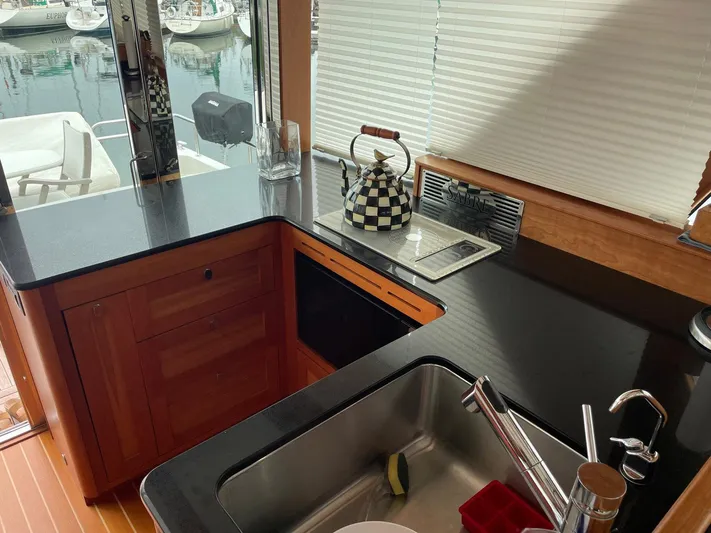 Last Resort Yacht Photos Pics Interior of 2021 Sabre 58 Salon Express yacht kitchen with modern fixtures and checkered teapot.