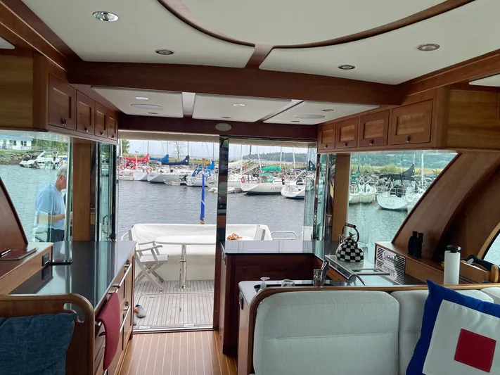 Last Resort Yacht Photos Pics Interior view of 2021 Sabre 58 Salon Express yacht with marina backdrop.