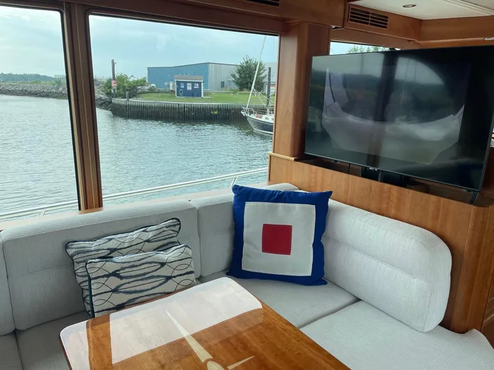 Last Resort Yacht Photos Pics Interior of 2021 Sabre 58 Salon Express yacht with waterfront view and modern decor.