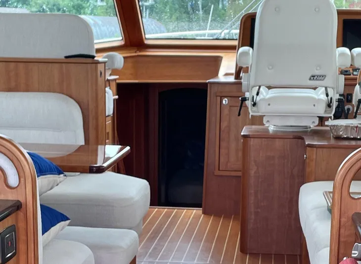 Last Resort Yacht Photos Pics Interior of 2021 Sabre 58 Salon Express yacht with luxurious seating and wooden finishes.