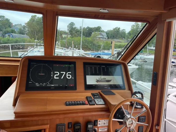 Last Resort Yacht Photos Pics 2021 Sabre 58 Salon Express helm with navigation screens and wooden steering wheel.