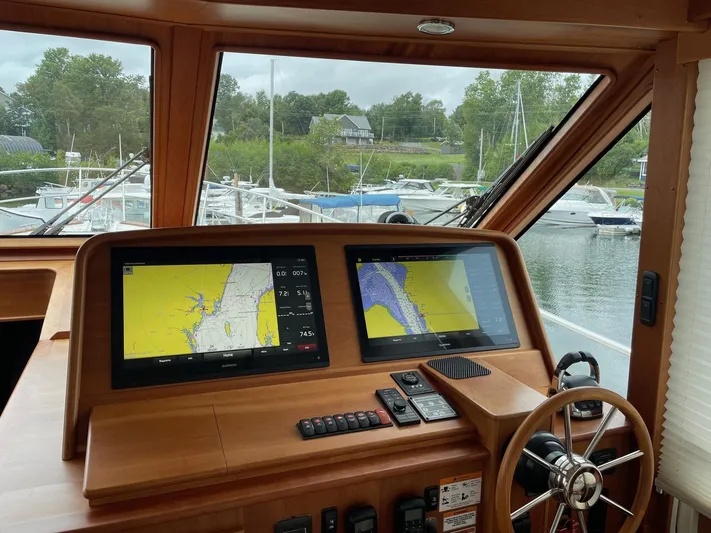 Last Resort Yacht Photos Pics Helm of 2021 Sabre 58 Salon Express with navigation screens and steering wheel.