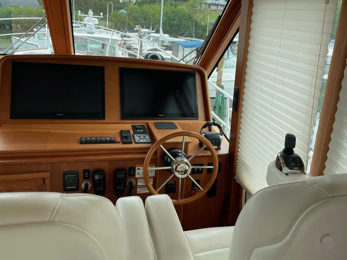 Last Resort Yacht Photos Pics Helm of 2021 Sabre 58 Salon Express with dual screens and wooden steering wheel.