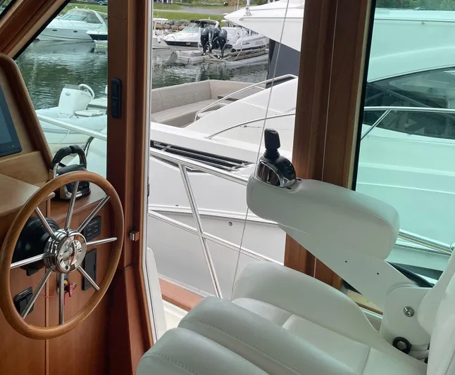 Last Resort Yacht Photos Pics Interior view of 2021 Sabre 58 Salon Express yacht helm with steering wheel and controls.