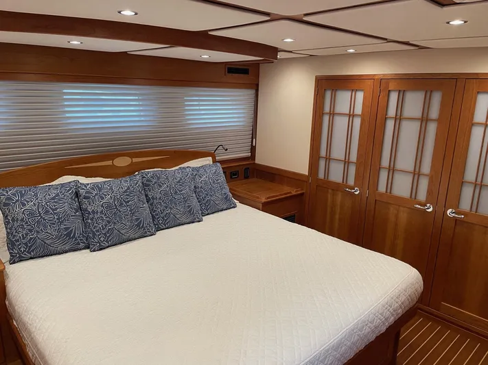Last Resort Yacht Photos Pics Luxurious bedroom interior of 2021 Sabre 58 Salon Express yacht with wood accents and cozy bedding.