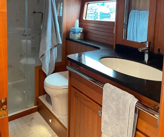 Last Resort Yacht Photos Pics Luxurious bathroom in 2021 Sabre 58 Salon Express yacht with modern fixtures and wooden cabinetry.