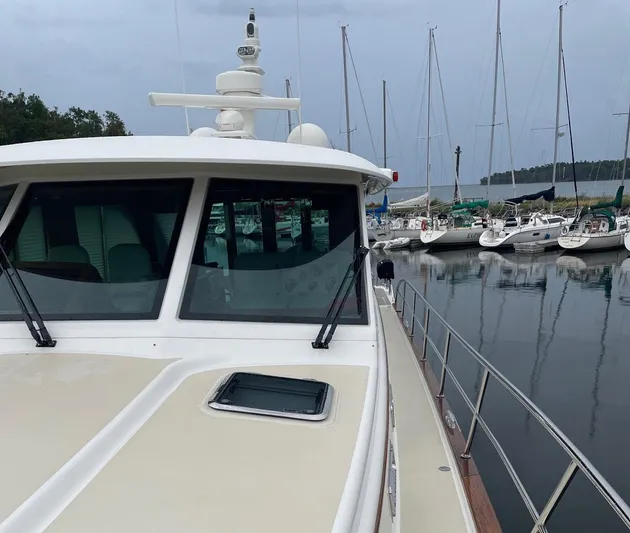 Last Resort Yacht Photos Pics 2021 Sabre 58 Salon Express yacht docked at marina with sailboats in background.
