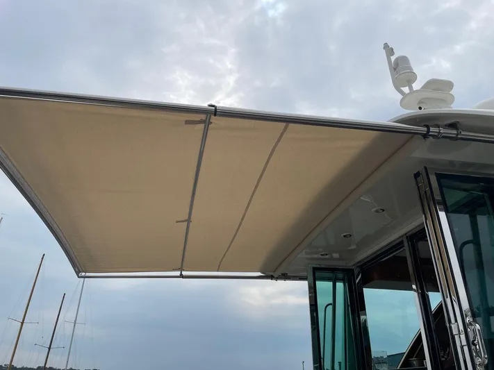 Last Resort Yacht Photos Pics 2021 Sabre 58 Salon Express with extended awning under cloudy sky.