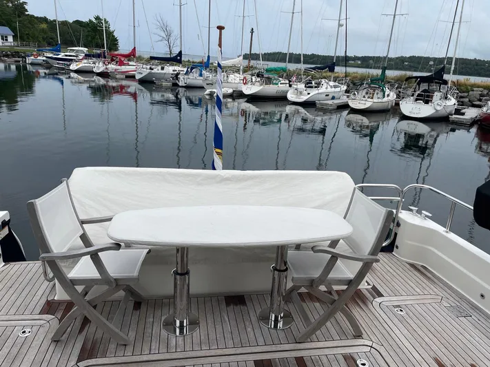 Last Resort Yacht Photos Pics 2021 Sabre 58 Salon Express yacht with elegant deck seating, docked at a marina.