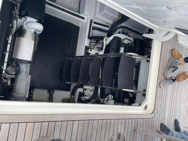 Last Resort Yacht Photos Pics Engine compartment of 2021 Sabre 58 Salon Express yacht, showing mechanical components and deck flooring.