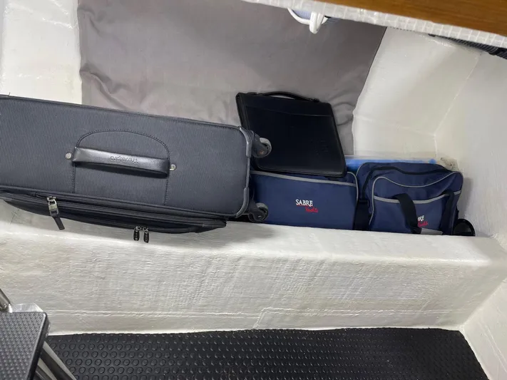 Last Resort Yacht Photos Pics Storage compartment in 2021 Sabre 58 Salon Express with luggage and bags.