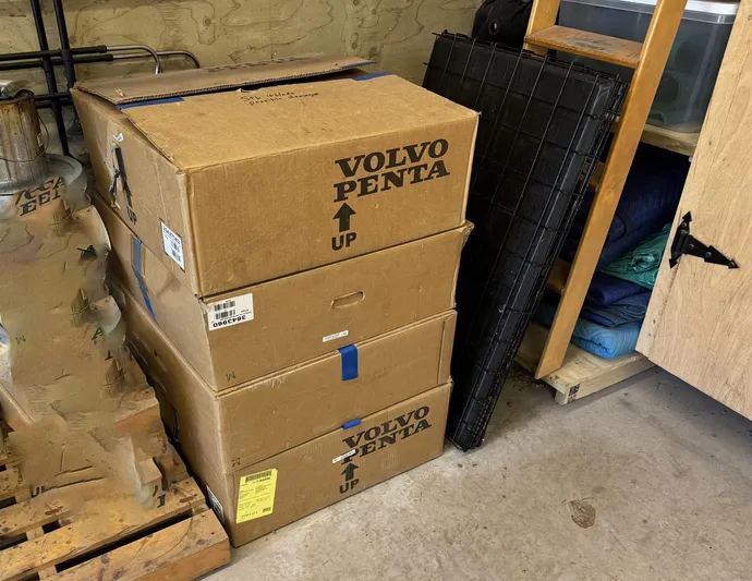 Last Resort Yacht Photos Pics Stacked Volvo Penta boxes in a garage, near a 2021 Sabre 58 Salon Express.