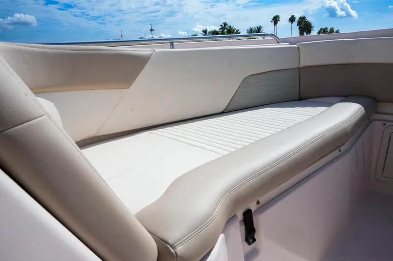  Yacht Photos Pics 2014 Grady-White Freedom 307 boat interior with cushioned seating under blue sky.