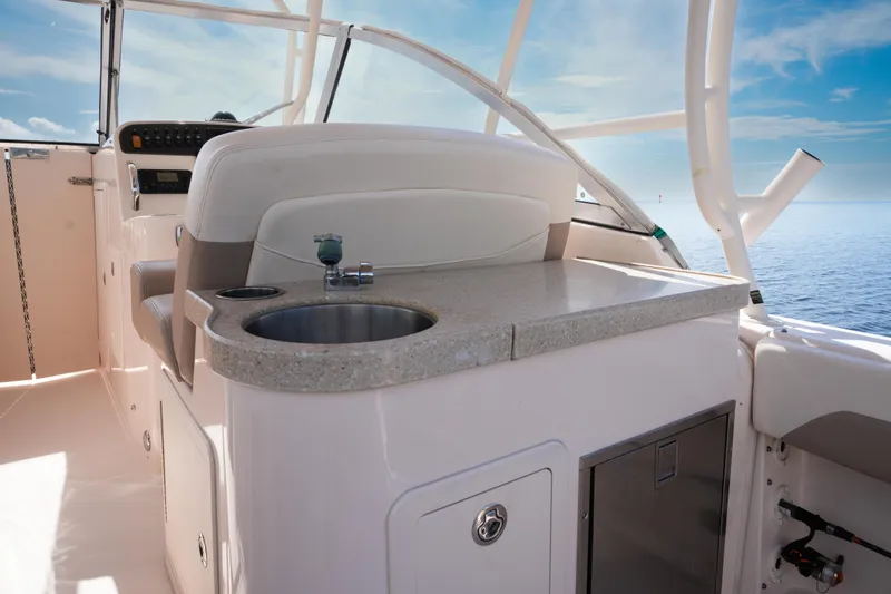  Yacht Photos Pics 2014 Grady-White Freedom 307 boat interior with sink and seating, ocean view.