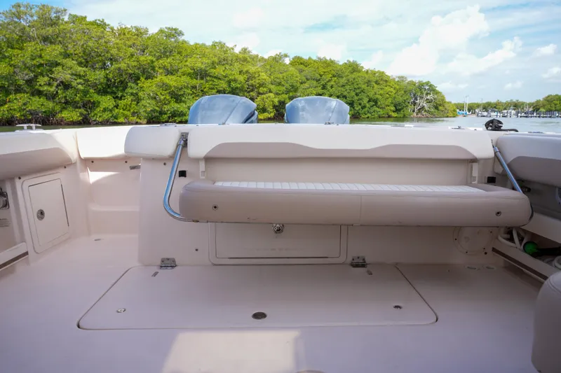  Yacht Photos Pics 2014 Grady-White Freedom 307 boat interior with seating, near lush greenery and calm waters.